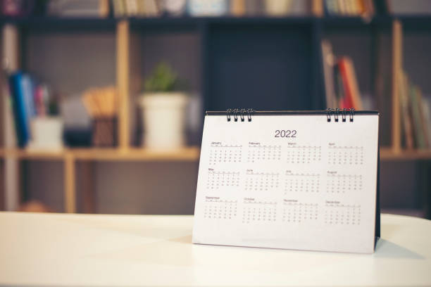 istock 2022 Calendar desk place on the table. Desktop Calender for Planner to plan agenda, timetable, appointment, organization, management each date, month, and year on wooden office table. Calendar Concept 1367951883
