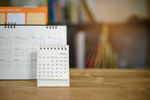istock 2022 Calendar desk place on the table. Desktop Calender for Planner to plan agenda, timetable, appointment, organization, management each date, month, and year on wooden office table. Calendar Concept 1367951884