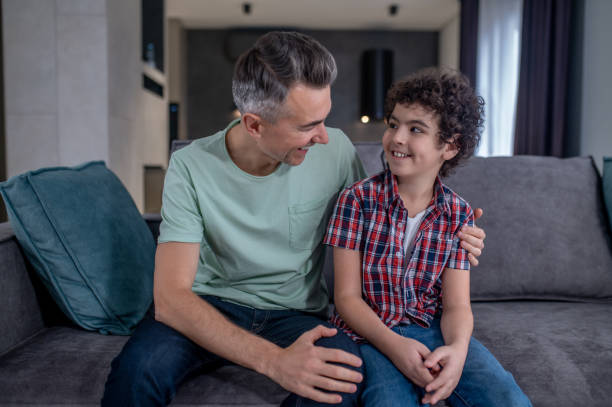 istock Father hugging son looking at each other 1367953296