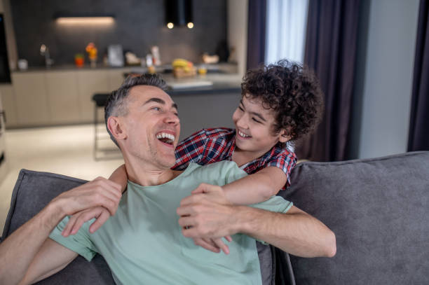 istock Son and father laughing looking at each other 1367953305