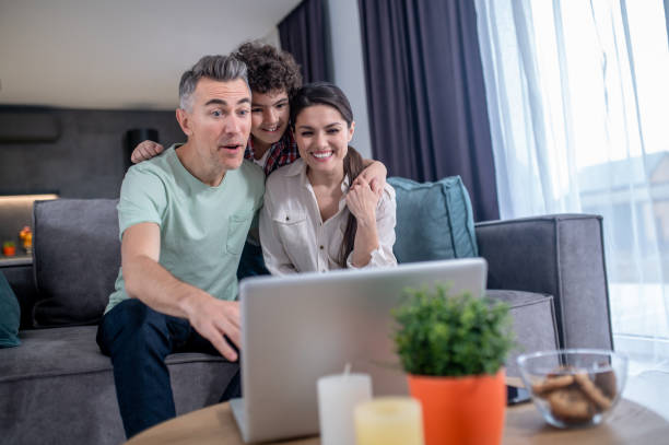 istock Man woman with son talking on video call 1367953336