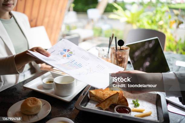 Colleagues Work Together At A Restaurant Business Dining With A Sense Of Place Stock Photo - Download Image Now