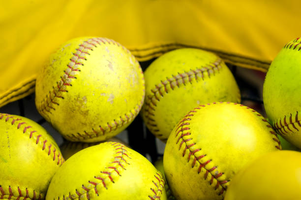 many used slowpitch softballs inside a ball caddy or basket. - catching horizontal nobody baseballs imagens e fotografias de stock