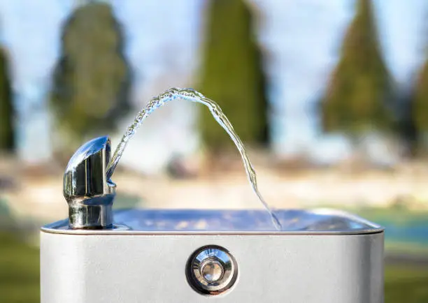 Photo of Drinking water fountain in park on a sunny day, no person.