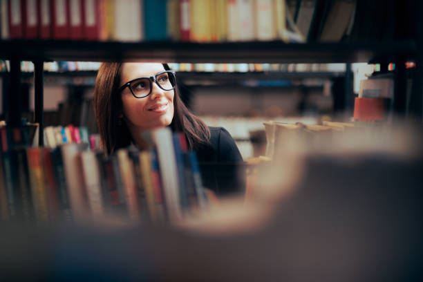 istock Smart Woman Looking at Bookshelves in a Library 1367957735