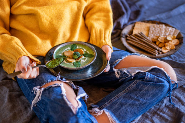istock A young girl lye on her bed and drinking her broccoli and spinach soup. 1367958863