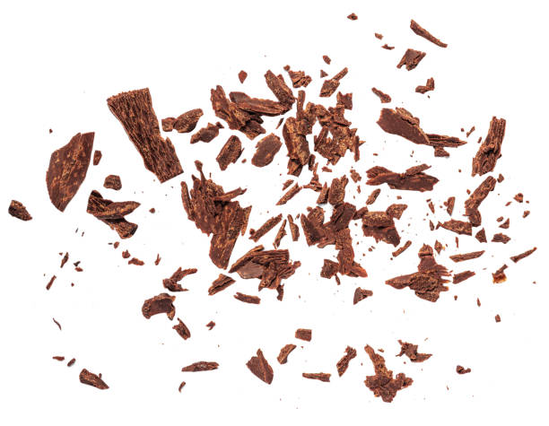 istock Grated Chocolate pieces isolated on white background. Crushed dark chocolate Top view. Flat lay