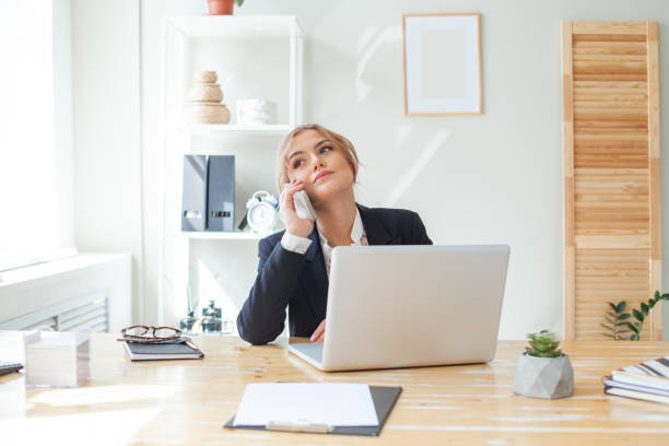 istock Young businesswoman using mobile phone in modern office 1367959763