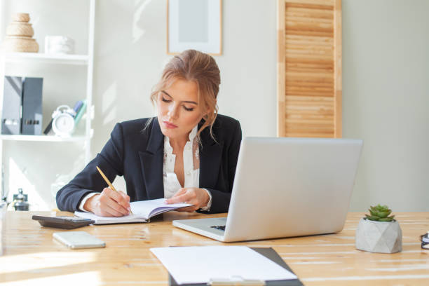 istock Businesswoman taking note of orders from customers 1367959769