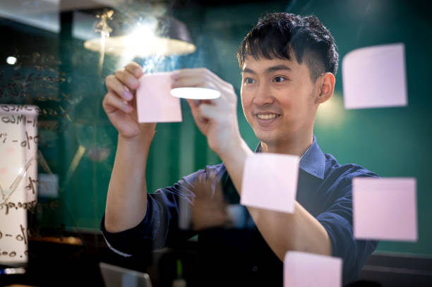 istock Young Asian millennial discussing work in co-working space 1367960735
