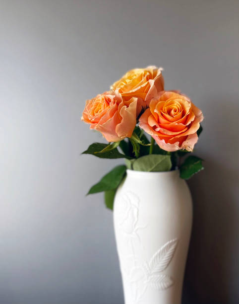 istock Landscape with yellow roses and white vases 1367960964