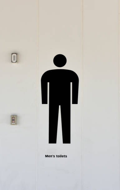 Close-up of men's restroom sign on the wall.