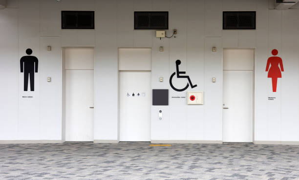 Close-up of public restroom sign on the wall.