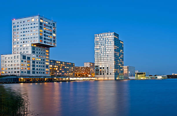 Highrise along water after sunset