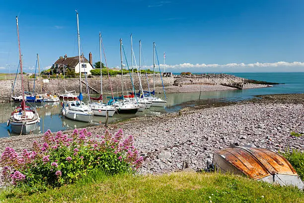 Boats in the outer harbour at Porlock Weir, Somerset England UK