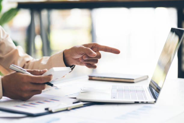 istock Asian business man working and data analysis with computer laptop in office, business financial and investment concept. 1367962656