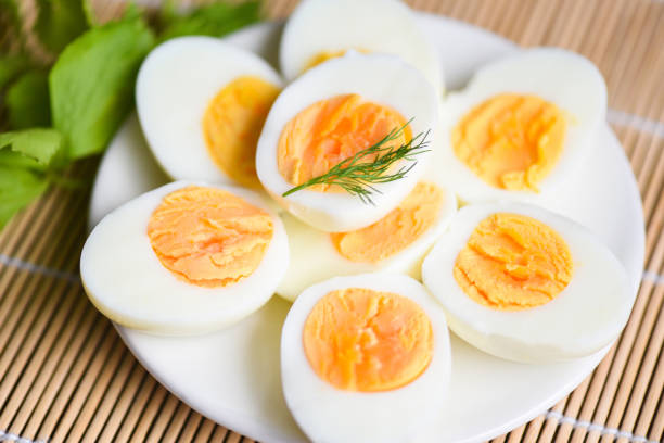istock Eggs breakfast, fresh eggs menu food boiled eggs in a white plate decorated with leaves green dill background, cut in half egg yolks for cooking healthy eating 1367962703