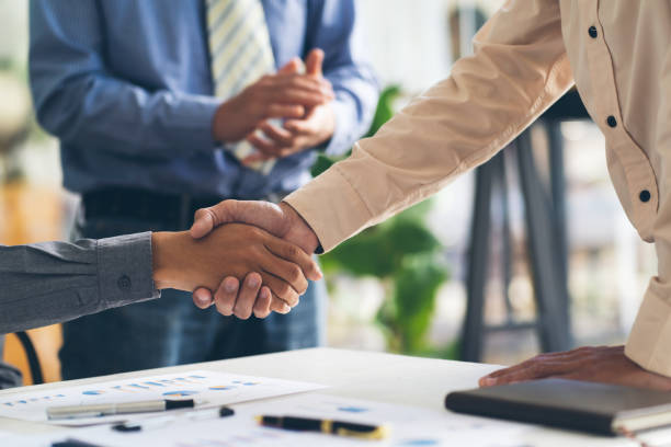 istock Real estate broker agent and customer shaking hands after signing contract documents for realty purchase, Bank employees congratulate, Concept mortgage loan approval. 1367962841