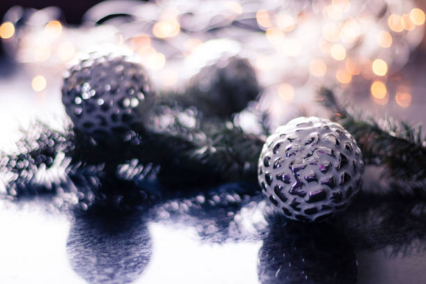 istock Christmas toy, silver ball on Christmas tree branch. Copy space 1367962996