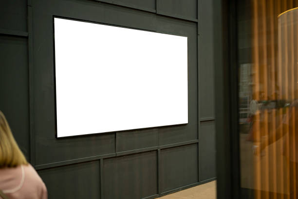 istock A large, blank billboard is mounted on the wall between the corridors. 1367964057