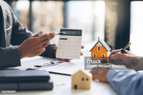 House Model With Agent And Customer Discussing For Contract To Buy Get Insurance Or Loan Real Estate Or Property Stock Photo - Download Image Now