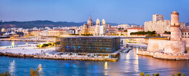 Entrance to Old Port of Marseille, France Panoramic view of Fort Saint-Jean with Marseille Cathedral and Mucem museum at sunset, France old port photos stock pictures, royalty-free photos & images