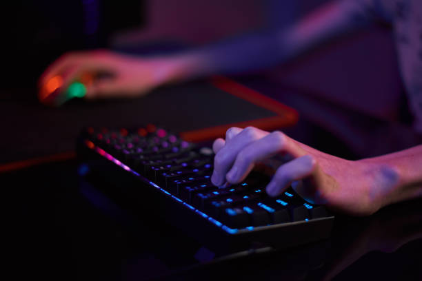 istock Gamer play computer game, use rgb neon colored keyboard 1367967201