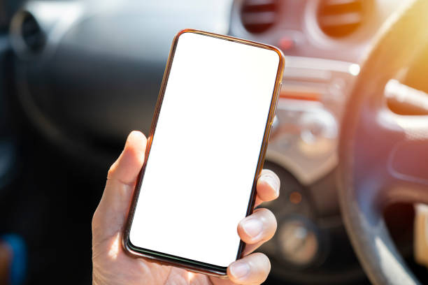istock A young man drives with a phone in his hand, 1367967273
