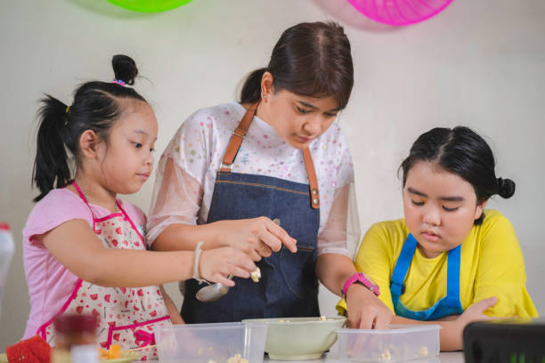 istock Asian mother and daughter enjoy making popcorn 1367967276