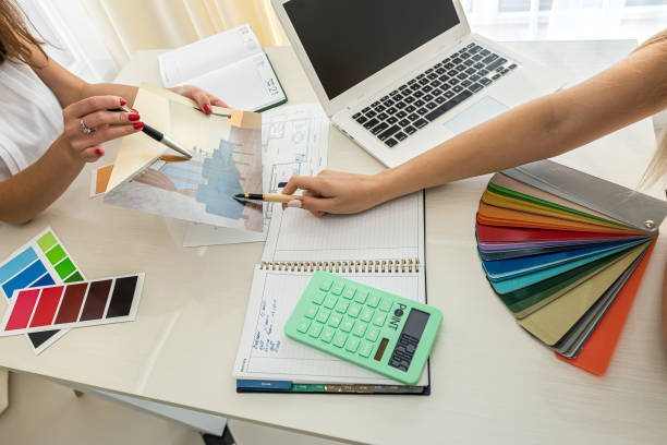 istock two colleagues interior designers discussing about color for renovation on house plan 1367970107