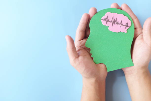 istock Hands holding human head profile cutout with healthy brain. Care for good memory, ADHD, Alzheimer, stroke, dementia prevention and world mental health day awareness concept. 1367970704