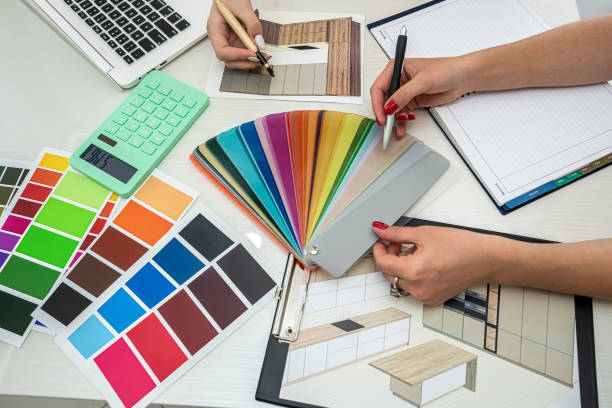 istock two  perfect female workers in white blouses work at a spacious table on a new room design. 1367970761