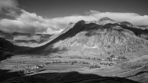istock Black and white Colorful vibrant Autumn landscape image looking from Pike O'Blisco towards Langdale Pikes and Range with beautiful sungiht on mountains and valley 1367973505