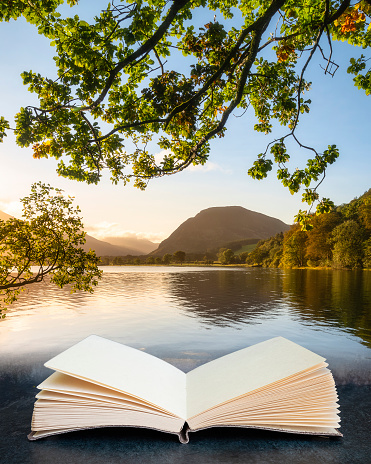 Digital composite image of Lovely sunrise landscape image looking along Loweswater in pages of imaginary open reading book