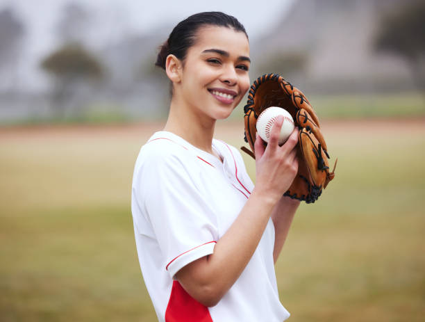 Cropped portrait of an attractive young female baseball player standing outside Ready? baseball uniform photos stock pictures, royalty-free photos & images