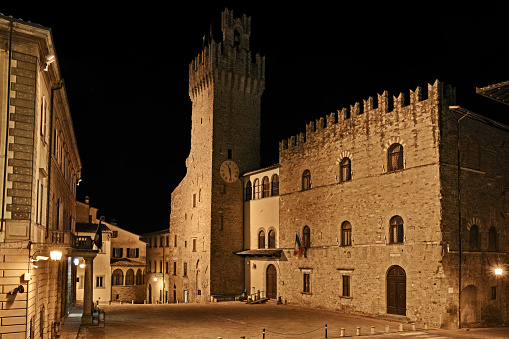 Arezzo, Tuscany, Italy: night view of the ancient town hall Palazzzo dei Priori and the square tower
