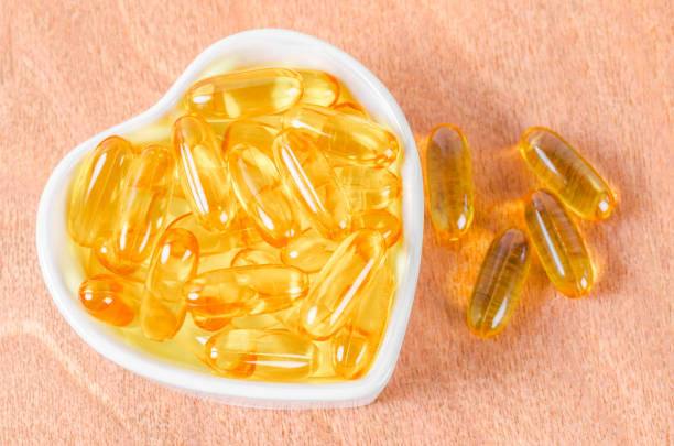 istock Heart-shape plate with fish oil capsules. 1367975569