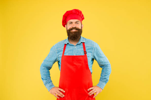 istock mature male chef on yellow backdrop. man cooking on kitchen. Professional chef man excited and smiling. excellent cook or baker. special offer from chef. chef in restaurant kitchen. Excellence 1367975708
