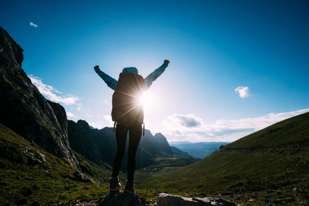 istock Successful woman backpacker hiking on alpine mountain peak 1367976049