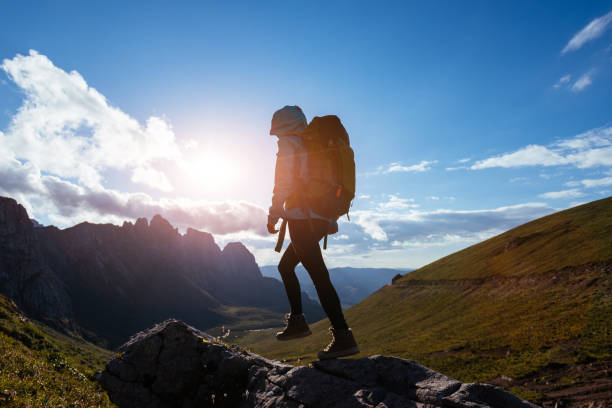 istock Solo woman backpacker hiking on alpine mountain peak 1367976063