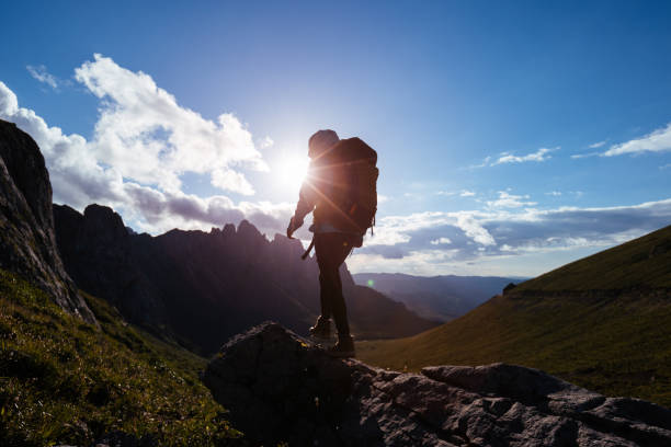 istock Solo woman backpacker hiking on alpine mountain peak 1367976071