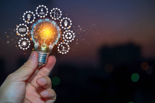 istock Hand holding light bulb against nature with icons energy sources for renewable 1367976747