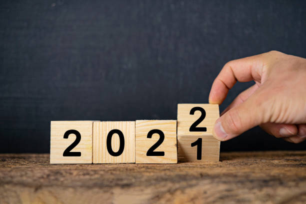 istock Hand changing Wooden Blocks With number 2021 to 2022 1367976749
