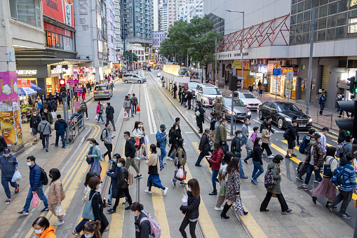 Hong Kong - January 31, 2022 :  Pedestrians walk past the Johnston Road in the Wan Chai District of Hong Kong.