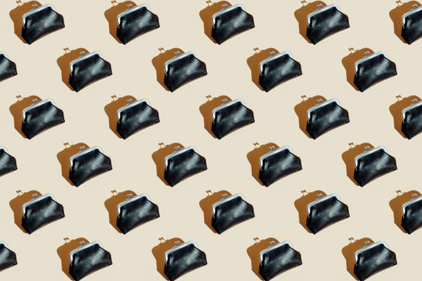 istock Top view of vintage black leather wallet. Pattern with hard shadow. Seamless pattern of many identical wallets 1367976929