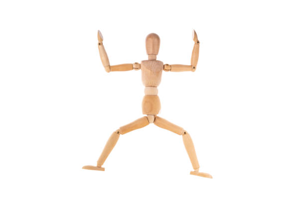 istock wooden man in a jump spread his arms isolated on a white background. Stretch concept 1367978015