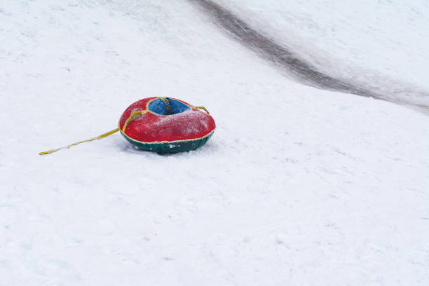 istock Tubing in winter from a snowy mountain 1367979029