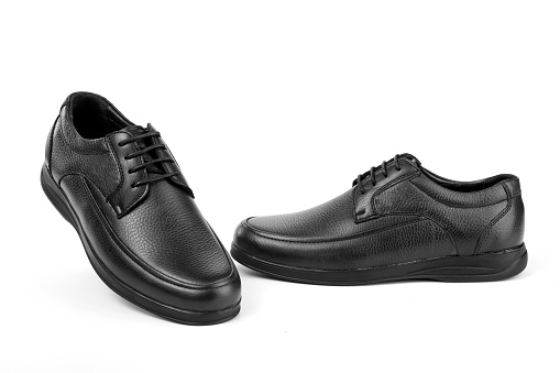 A pair of classic black men's shoes on a white background