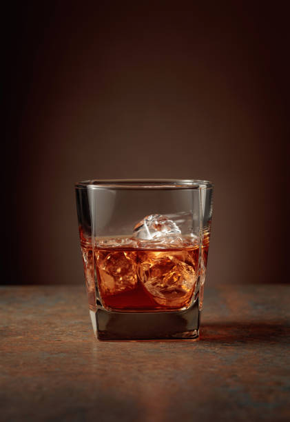 istock Whiskey with ice on an old vintage background. 1367981043