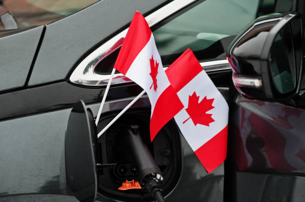 istock Canada flag ecological car concept. Plugging a power supplier, charging modern automobile. 1367982479